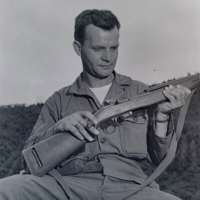 Soldier examining an M1 rifle