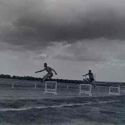 Soldiers running high hurdles