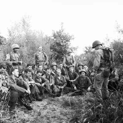 Infantry platoon receiving instructions during field training