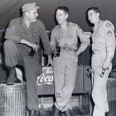 Soldiers relaxing with Cokes inside a tent