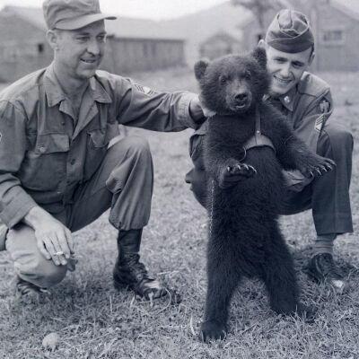 Two soldiers with a bear cub