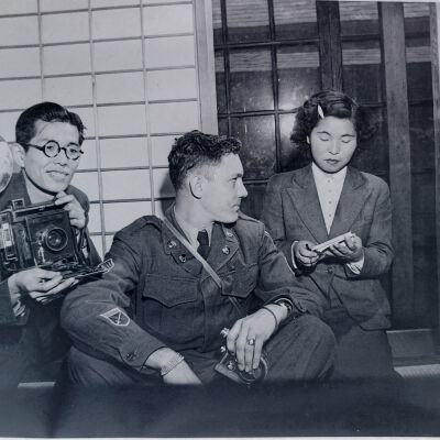 Soldiers with Japanese male photographer and a Japanese woman in a civilian building