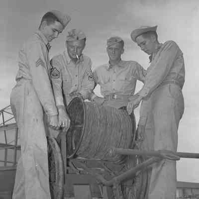 Soldiers with a roll of commo wire