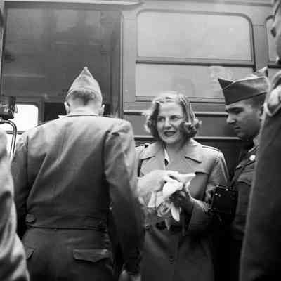 Soldiers and woman boarding a bus