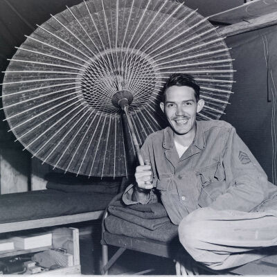 Soldier posing with a parasol