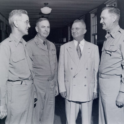 Generals Styron, Eagles, McLain, Middleton conversing in an office