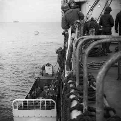 Soldiers climbing into landing craft