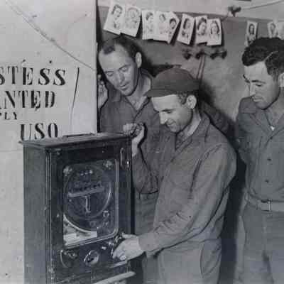 Soldiers playing with slot machine