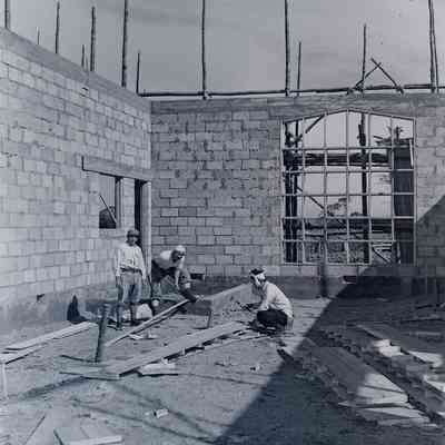 Japanese civilians constructing a brick building