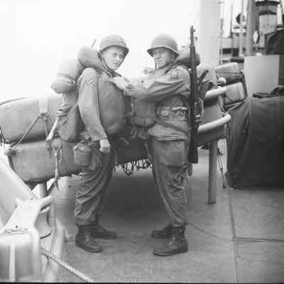 Soldiers checking each other's life vests
