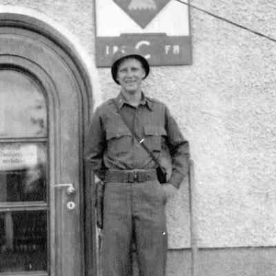 Soldier in front of sign