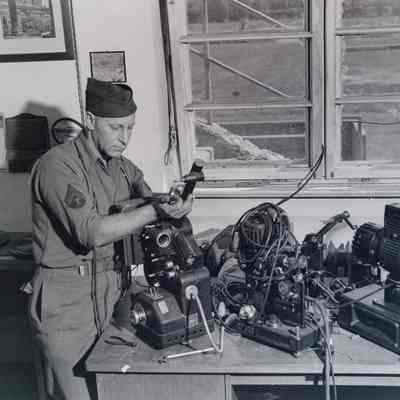 Soldier fixing movie projectors