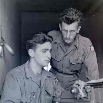 Two soldiers working at desk