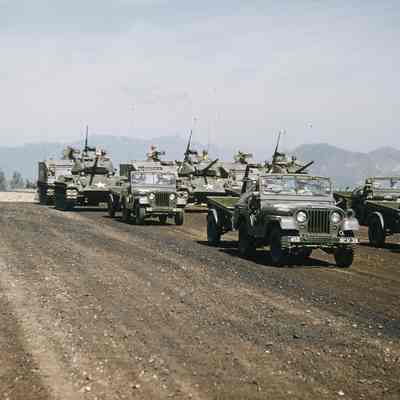 Military vehicles driving by during a review