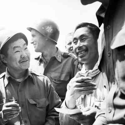 Japanese men laughing with soldiers