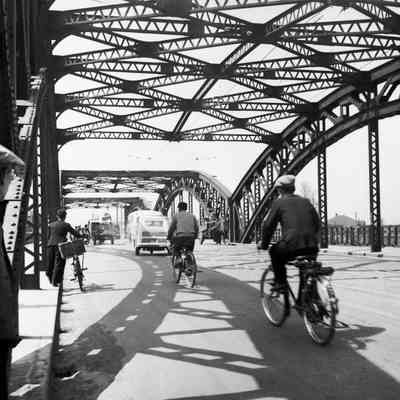 Civilian traffic over a steel-arch bridge