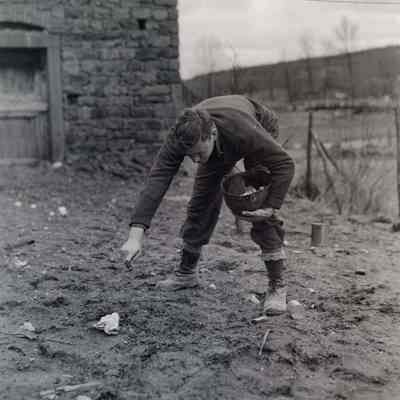 Soldier picking up garbage