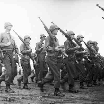 Soldiers marching with shouldered rifles