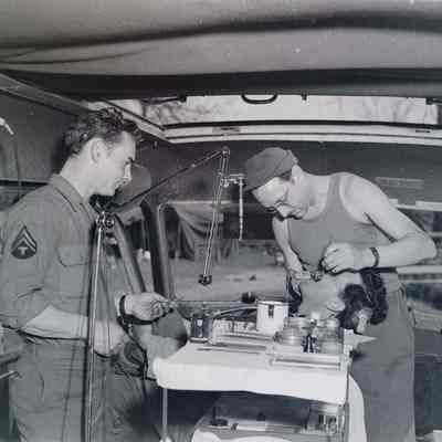 Dentist working on soldier in mobile clinic