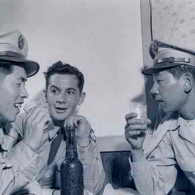 Soldier drinking with two members of the Japanese National Police Reserve