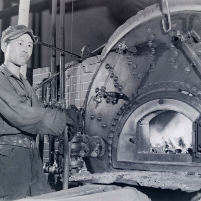 Japanese man stoking a boiler