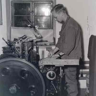 Soldier operating printing press