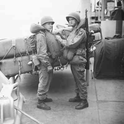 Soldiers checking each other's life vests