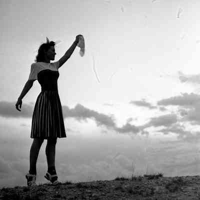 Girl waving goodbye with a handkerchief