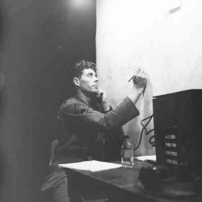 Soldier using communication gear and marking a wall map