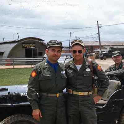 Group photo of officers in front of jeep