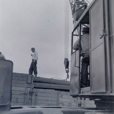 Soldiers using a crane to load cargo