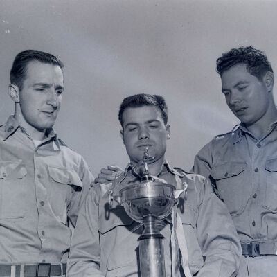 Soldiers with a baseball trophy