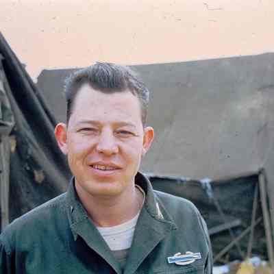 Solider standing in front of tents