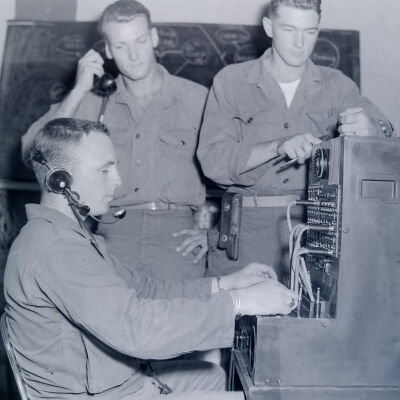 Three soldiers operating telephone switchboard