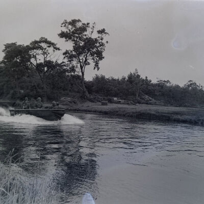 Soldiers in a motorboat on a river