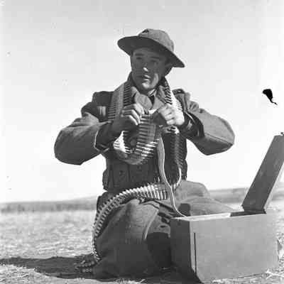 Soldier filling ammunition belt