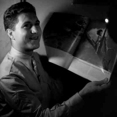 Soldier holding a magazine of cheesecake photos
