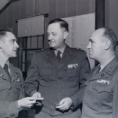 General Styron with two soldiers in an office