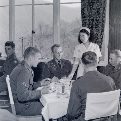 Soldiers at table in a hotel dining room