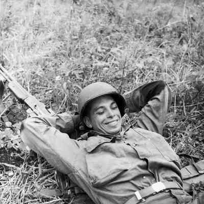 Portrait of a soldier resting with his rifle