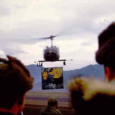 Helicopter holding sign commemorating the time the 45th Division served in Korea