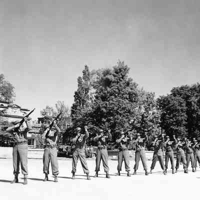 Soldiers aiming rifles