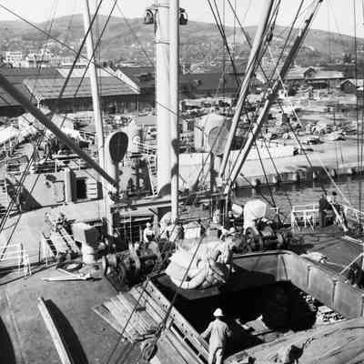 Cargo ship unloading cargo in port