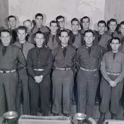 Group shot of soldiers in front of map