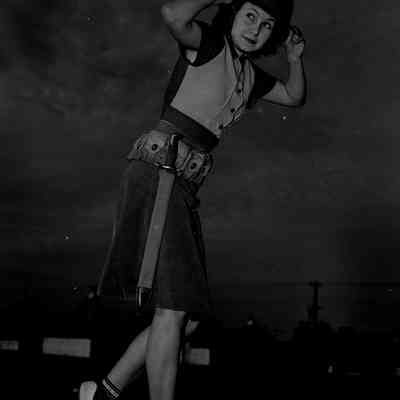 Girl wearing a helmet and pistol belt with bayonet