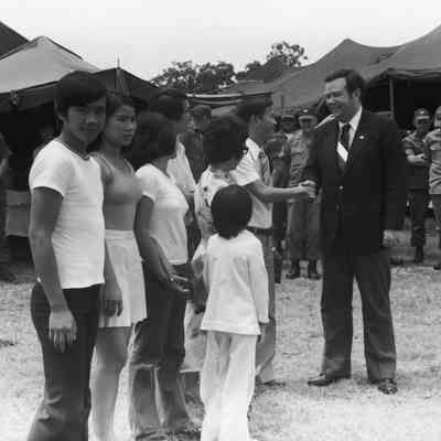 Govenor David Boren meeting a refugee family from Vietnam