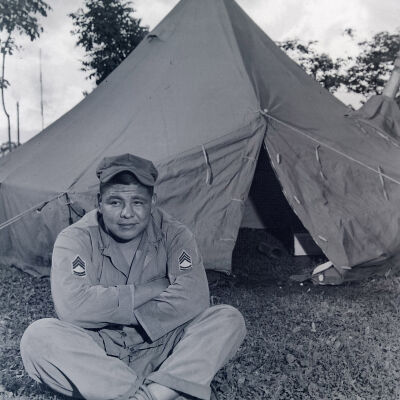 Tom Bear sitting in front of tent