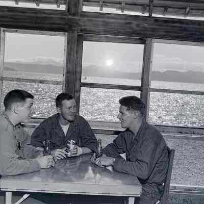Three soldiers inside a lakeside Japanese restaurant