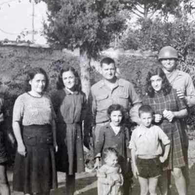 Solider posing with Italian Locals