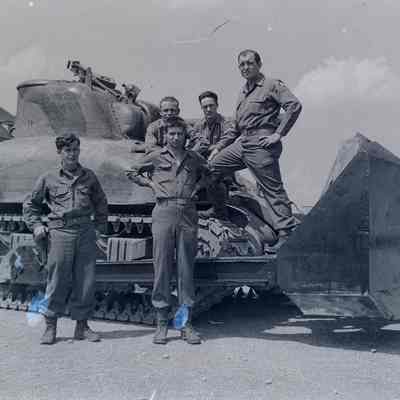 Soldiers standing on an M-4 Tank Dozer